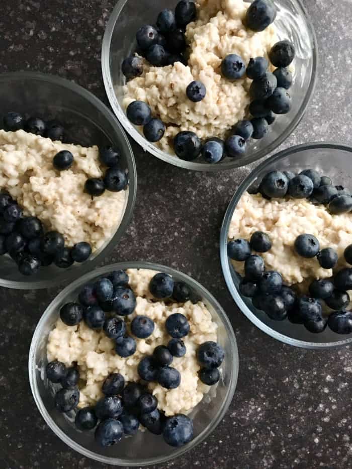 glass bowl with oatmeal and blueberries.