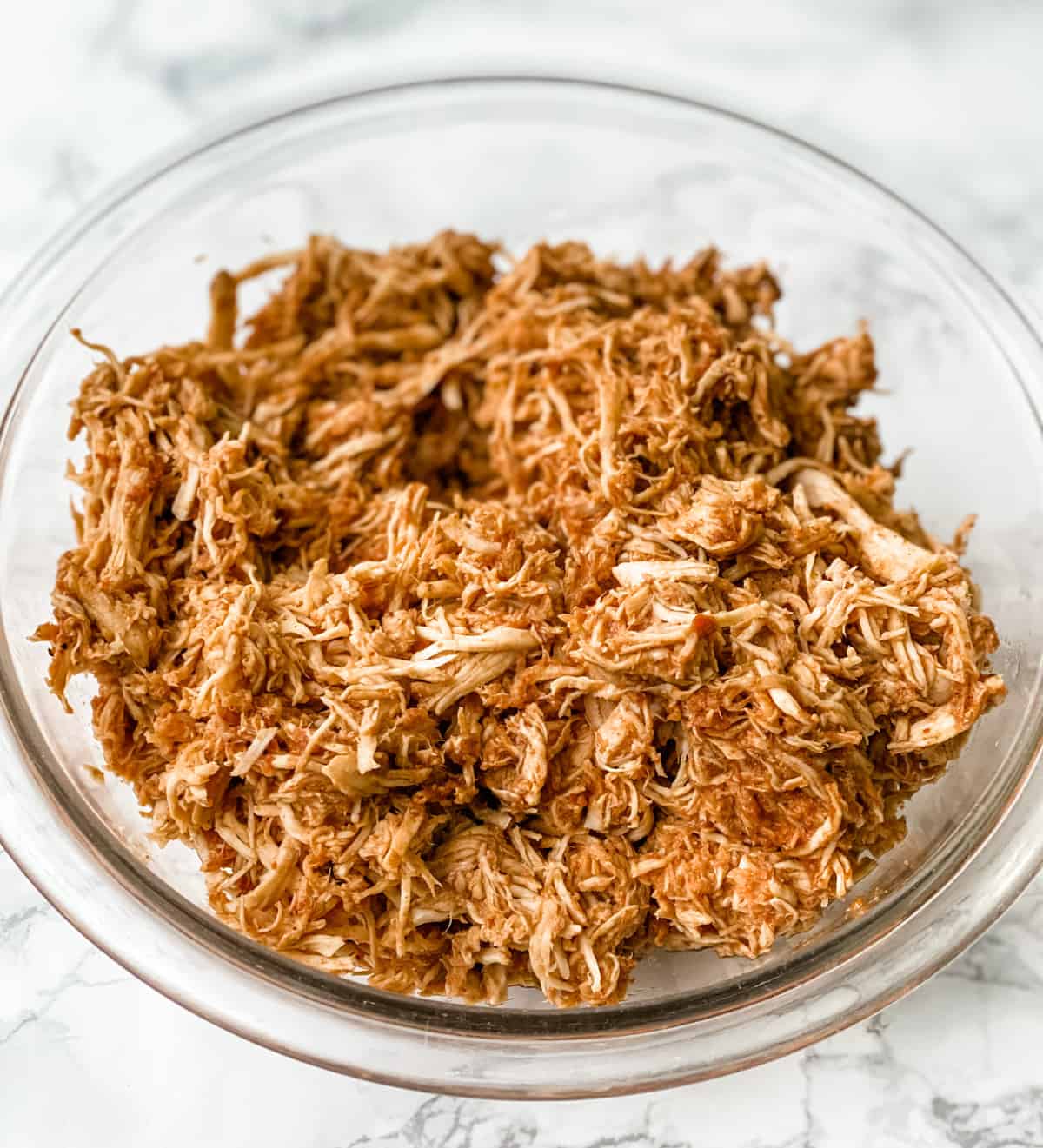 a bowl with shredded mexican chicken.
