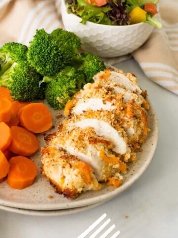 baked chicken ranch on a plate with carrots and broccoli