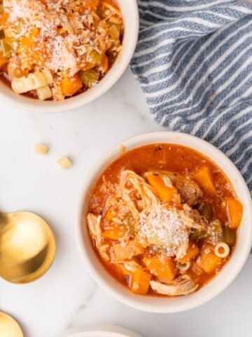 overhead closeup view of two bowls of italian chicken soup.